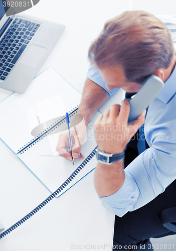 Image of handsome businessman talking on the phone