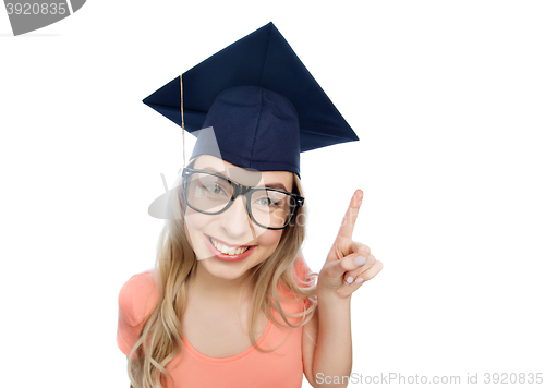 Image of smiling young student woman in mortarboard