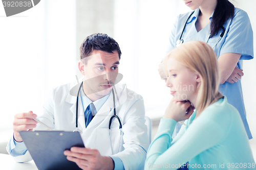 Image of doctor and nurse with patient in hospital