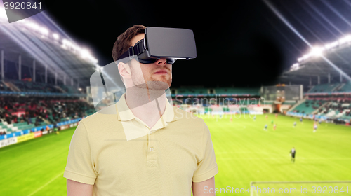 Image of man in virtual reality headset over football field