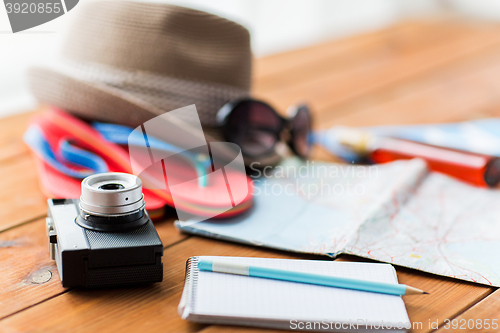 Image of close up of camera, notepad and travel stuff