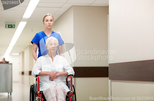 Image of nurse with senior woman in wheelchair at hospital