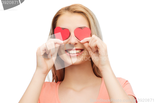 Image of happy young woman with red heart shapes on eyes