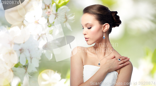 Image of beautiful woman with earring, ring and pendant