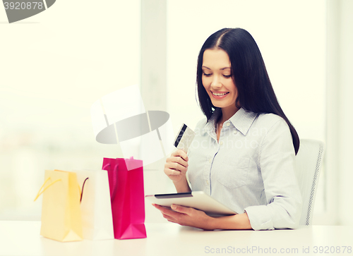 Image of smiling woman with blank screen tablet pc