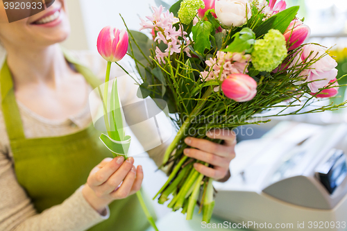 Image of close up of woman making bunch at flower shop