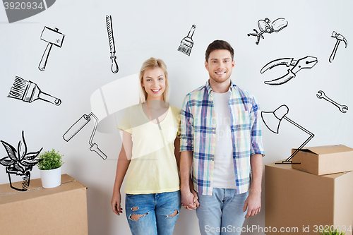 Image of smiling couple with big boxes moving to new home