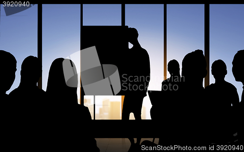 Image of business people silhouettes at meeting in office