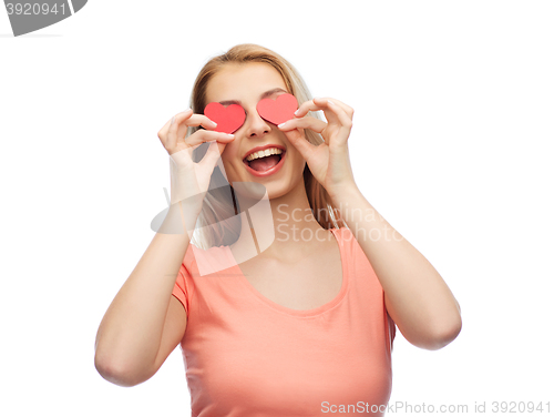 Image of happy young woman with red heart shapes on eyes