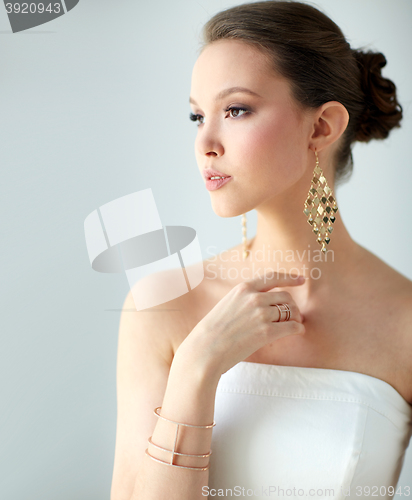 Image of beautiful asian woman with earrings and bracelet