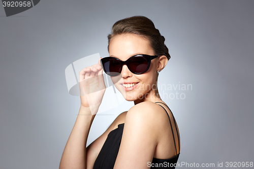 Image of beautiful young woman in elegant black sunglasses