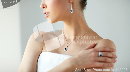 Image of beautiful woman with earring, ring and pendant