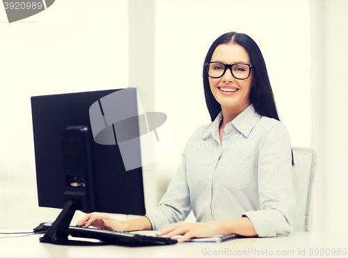 Image of smiling businesswoman or student with eyeglasses