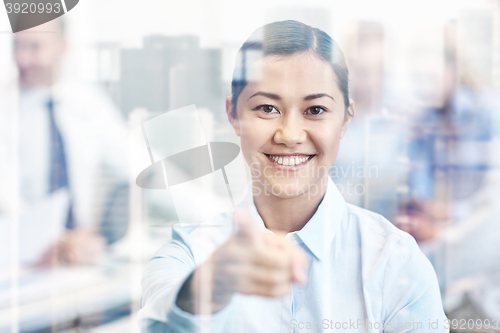 Image of group of smiling businesspeople meeting in office