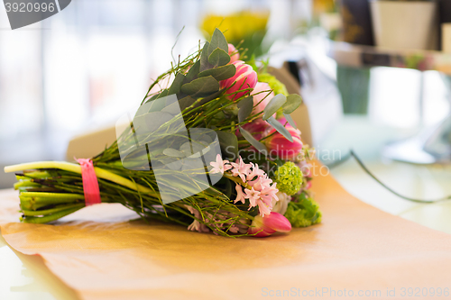 Image of close up of bunch on paper at flower shop