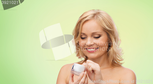 Image of happy woman with cream jar