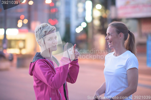 Image of couple warming up before jogging