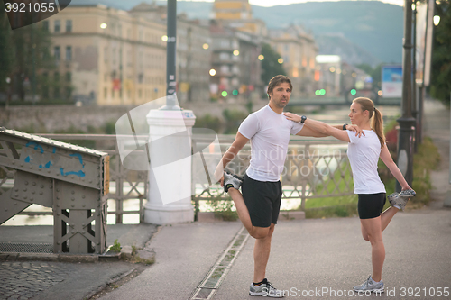 Image of couple warming up before jogging