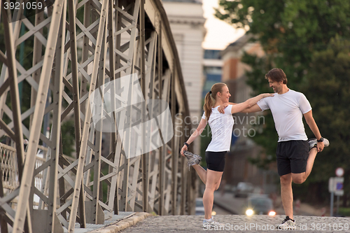 Image of couple warming up and stretching before jogging