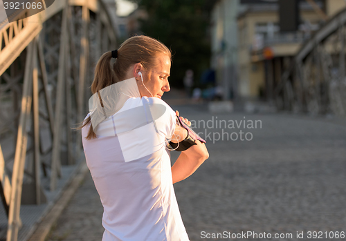 Image of jogging couple planning running route  and setting music