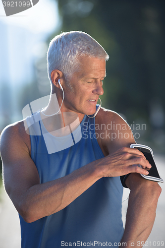 Image of portrait of handsome senior jogging man