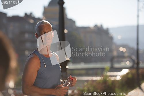 Image of portrait of handsome senior jogging man