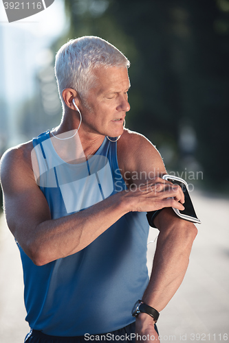 Image of portrait of handsome senior jogging man