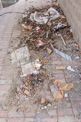 Image of Vityazevo, Russia - April 2, 2016: Garbage building and home to the paving tiles in the nook