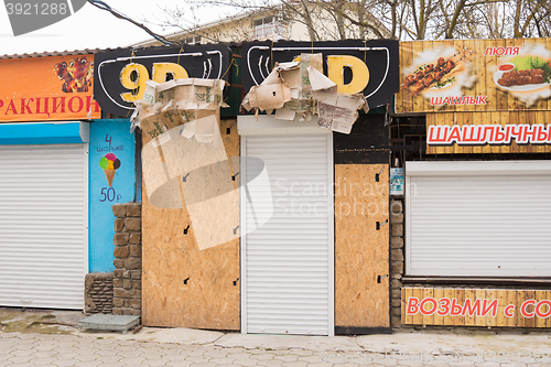 Image of  Sukko, Russia - March 15, 2016: Closed during the offseason 9D pavilion with advertising inscription on the seaside street at the Black Sea in the village of Sukkah, a suburb of Anapa