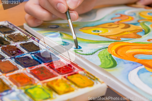 Image of Close-up watercolor brush and drawing them on paper