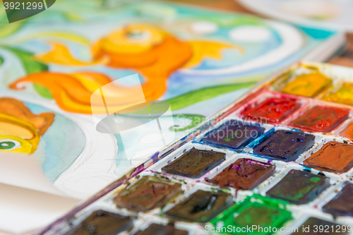 Image of Close-up of watercolors and a fragment of the picture goldfish
