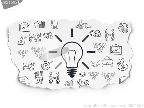 Image of Business concept: Light Bulb on Torn Paper background