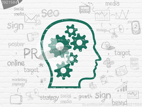 Image of Advertising concept: Head With Gears on wall background