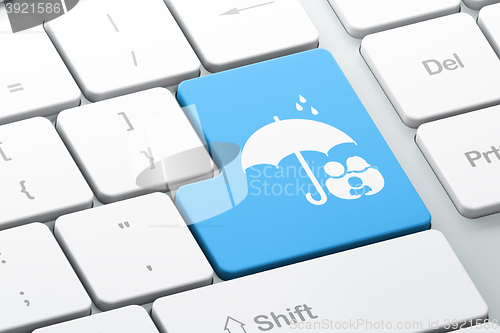 Image of Protection concept: Family And Umbrella on computer keyboard background