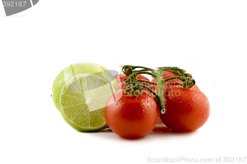 Image of Two limes and two tomatos isolated on white background