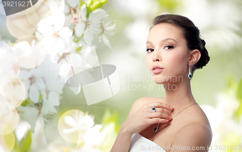 Image of beautiful woman with earring, ring and pendant