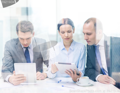 Image of business team with tablet pc having discussion