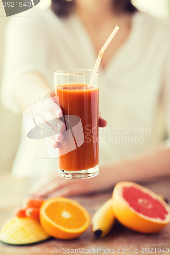 Image of close up of woman hands with juice and fruits