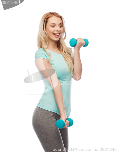 Image of happy beautiful young sporty woman with dumbbells