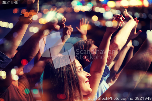 Image of smiling friends at concert in club