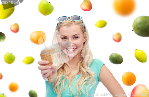 Image of happy young woman in sunglasses eating ice cream