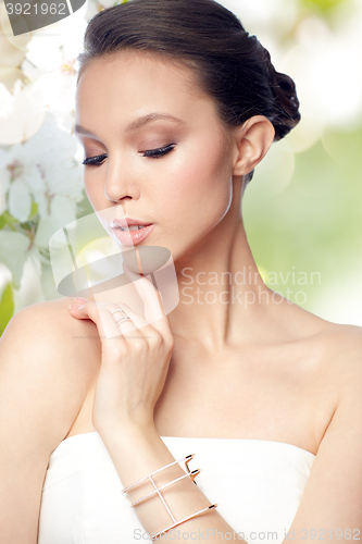 Image of beautiful asian woman with ring and bracelet