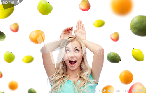 Image of happy smiling young woman making bunny ears