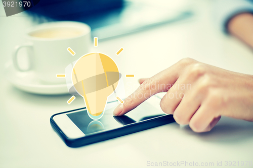 Image of close up of woman hand with smartphone and coffee