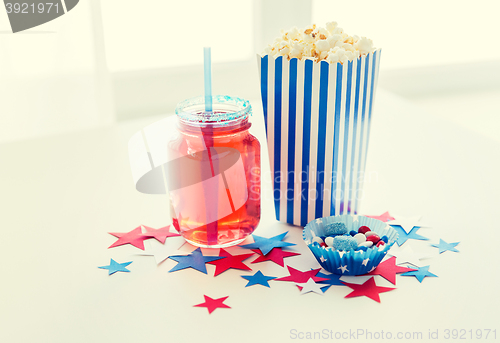 Image of drink and popcorn with candies on independence day