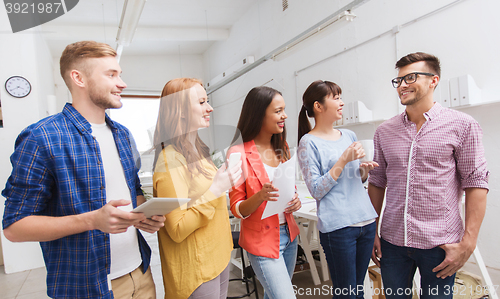 Image of creative team on coffee break talking at office