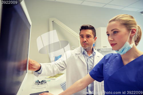 Image of dentists with x-ray on monitor at dental clinic