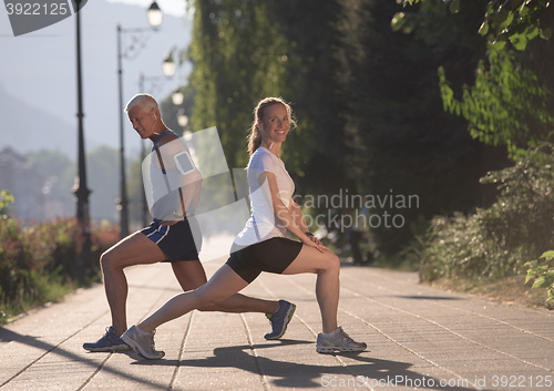 Image of couple warming up and stretching before jogging