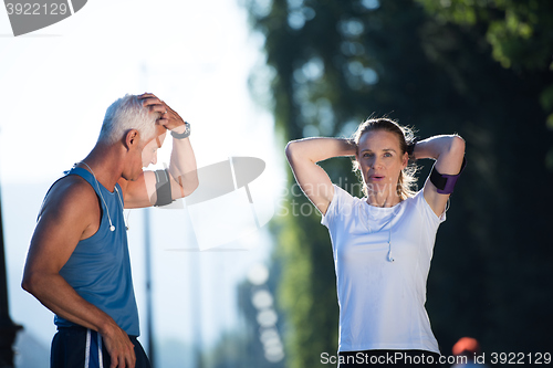 Image of jogging couple planning running route  and setting music