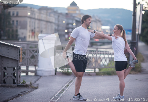 Image of couple warming up before jogging